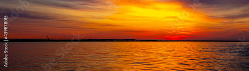 sunset in the bay somewhere in the distance harbor cranes