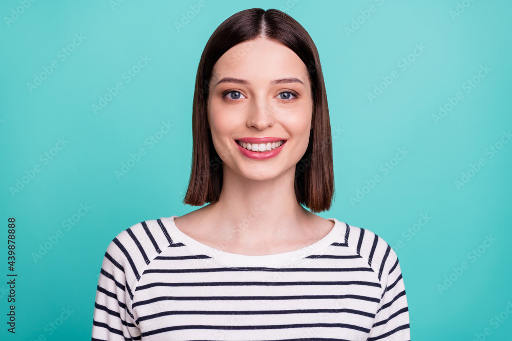 Photo of charming positive lady toothy beaming smile wear striped shirt isolated on turquoise background Photo of charming positive lady toothy beaming smile wear striped shirt isolated on turquoise background