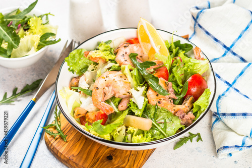 Seafood salad with fresh leaves tomatoes and fried seafood. Mediterranean diet.