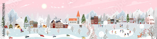 Winter wonderland landscape background at night with people having fun in the city on new year,Christmas day in village with people celebration, kids playing ice skate, teenager skiing on mountain