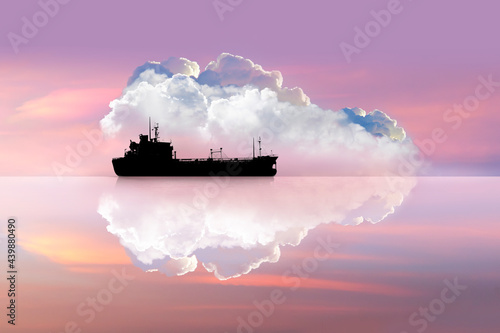 Pink sky and big clouds with the ship have reflection shadow - Ship heading out towards the sea in pink toned light