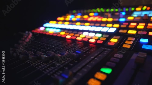 View on dj remote or soundboard with moving and brightly glow buttons. Working process of recording studio. Amplifier and balance of sound. Musical player at night party in club. Slow motion Close up photo