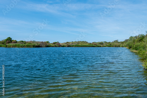 Water reservoir with dunes in the background