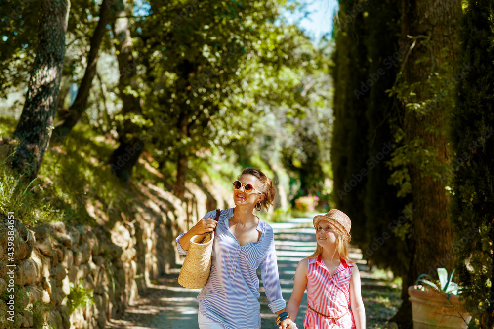 smiling mother and child travellers walking in Tuscany, Italy smiling mother and child travellers walking in Tuscany, Italy
