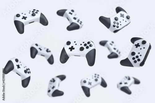 Flying gamer joysticks or gamepads on white background with blur