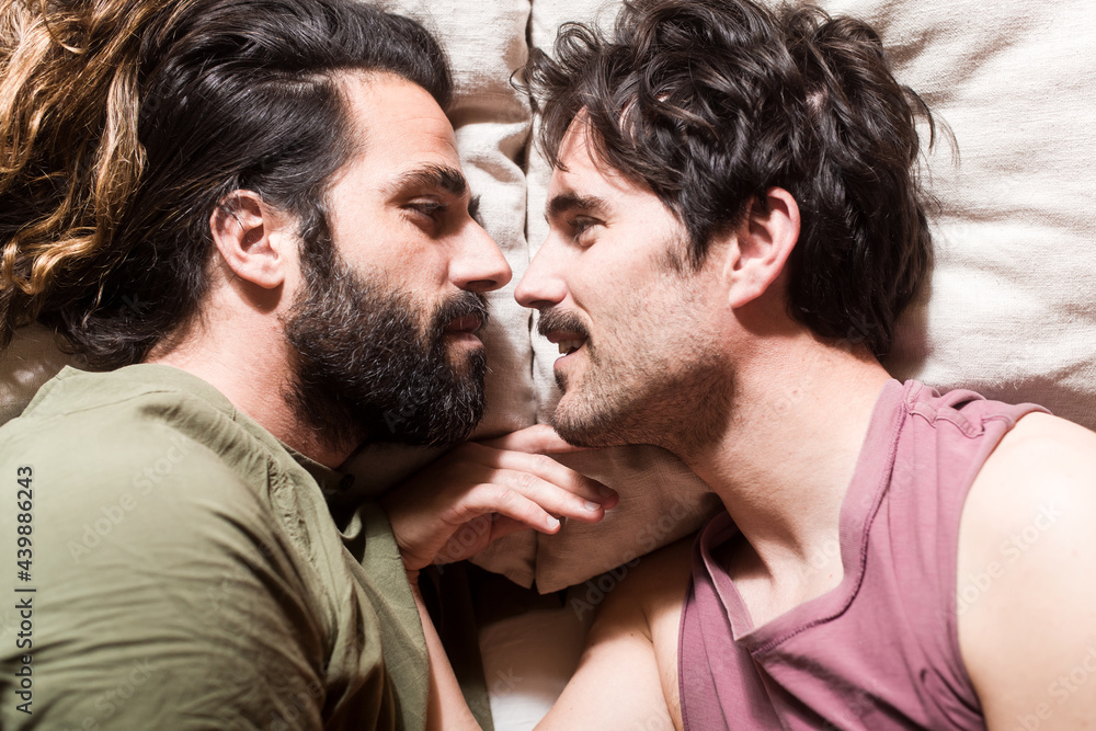 Gay couple sharing secrets on bed
Gay couple sharing secrets on bed