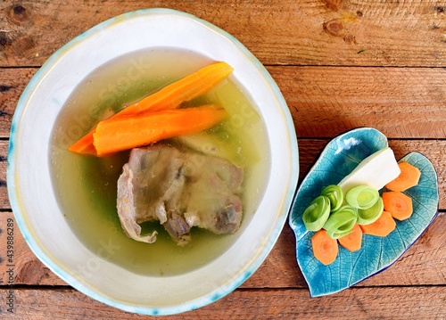 Vegetable soup on a plate on the wooden table photo