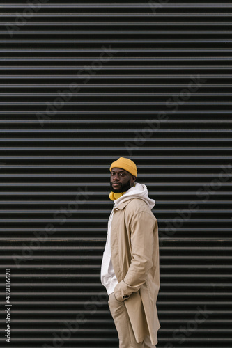 Man with yellow wireless helmets and cap facing the camera photo