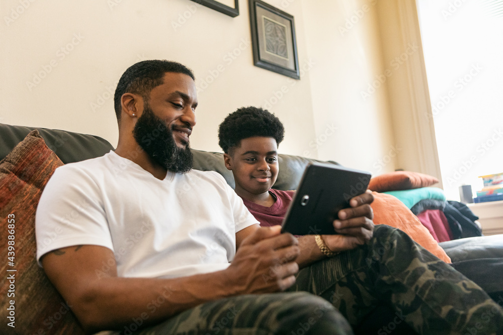 Father And Son Use Digital Tablet At Home Father And Son Use Digital Tablet At Home