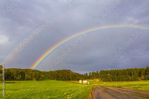 rainbow over the field viewed from the roadside © Umar