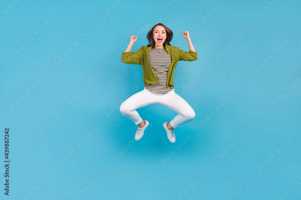 Full size photo of cheerful happy young woman winner lucky lady celebrate isolated on blue color background