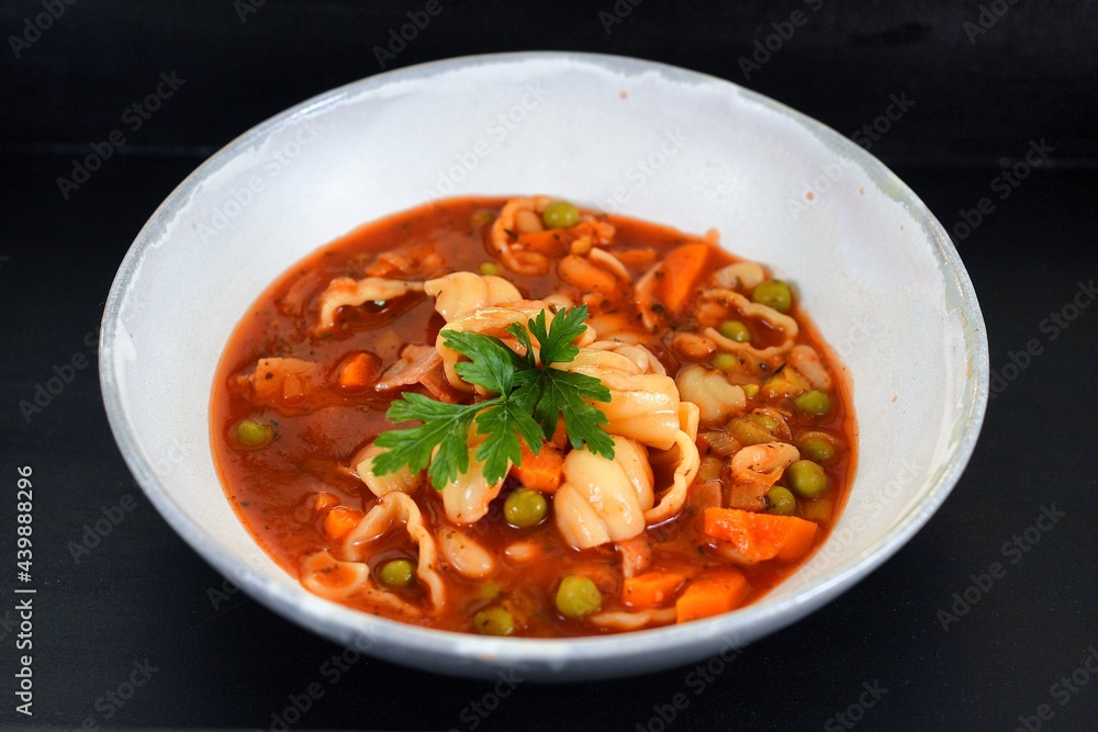 Vegetable soup on a plate on the wooden table Vegetable soup on a plate on the wooden table