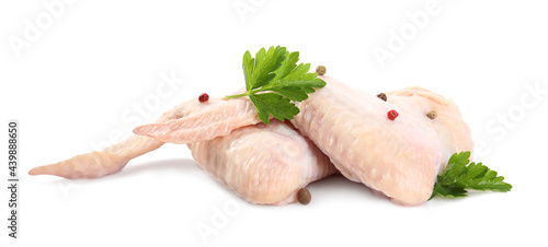 Raw chicken wings with spices and parsley on white background