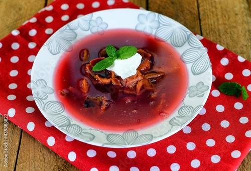 Vegetable soup on a plate on the wooden table