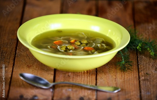 Vegetable soup on a plate on the wooden table photo