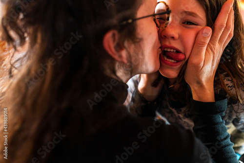 Mother giving affection and love her daughter 