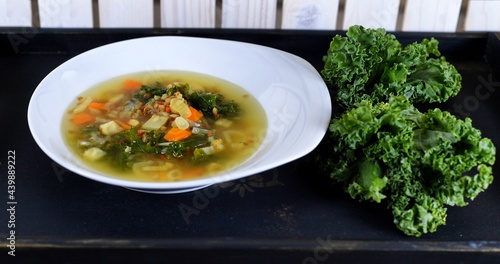 Vegetable soup on a plate on the wooden table