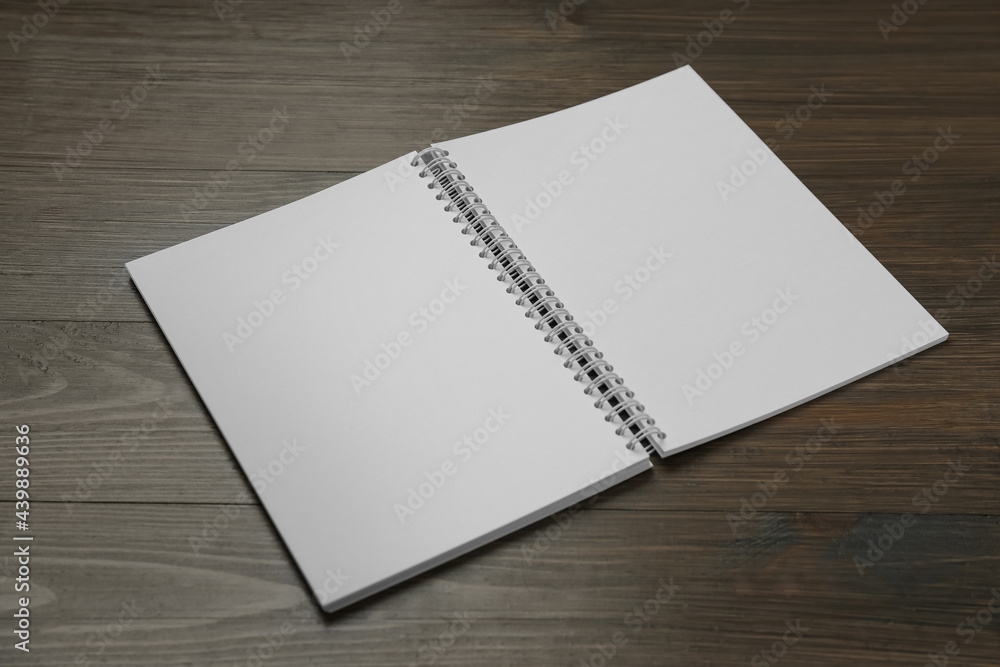 Blank paper brochure on wooden table. Mockup for design Blank paper brochure on wooden table. Mockup for design