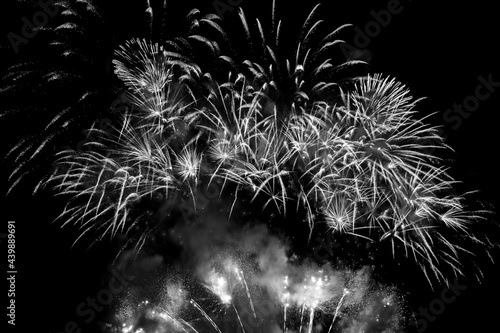 Sparkling white fireworks display in a black sky. Black and white photograph.