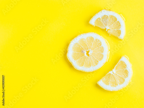 Intense yellow lemon citrus slice in water, texture summer background