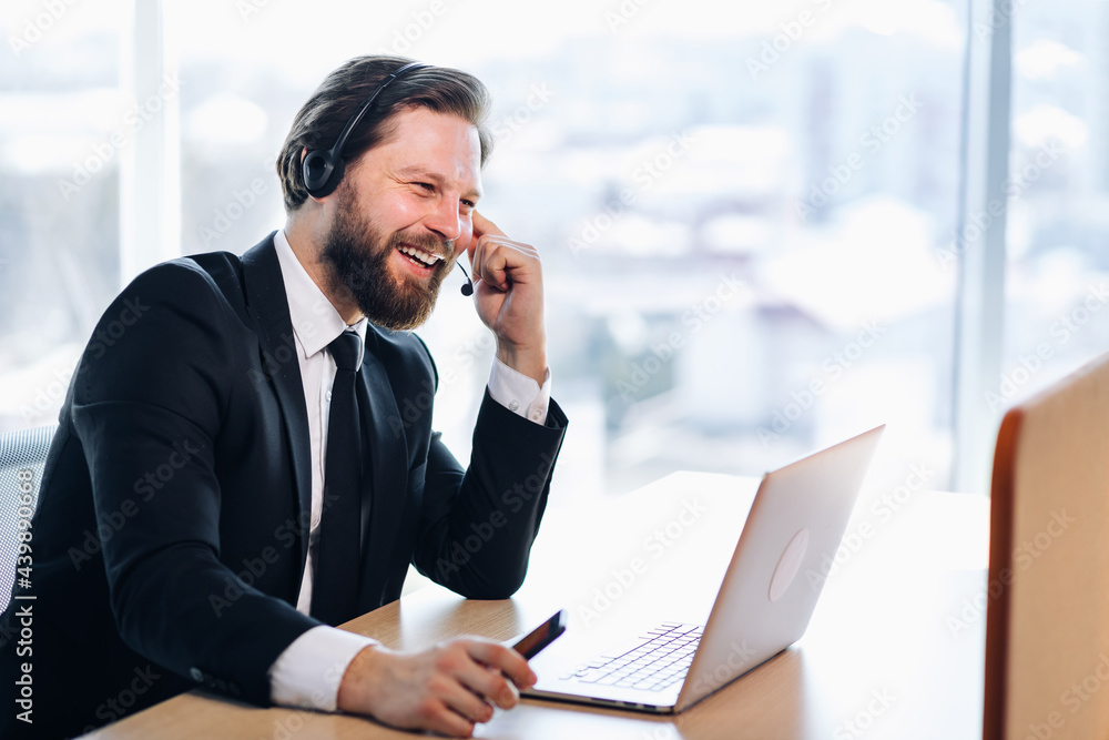 The technical support manager in the headset advises the customer. Sits in a modern office, communicates video communication. The technical support manager in the headset advises the customer. Sits in a modern office, communicates video communication.