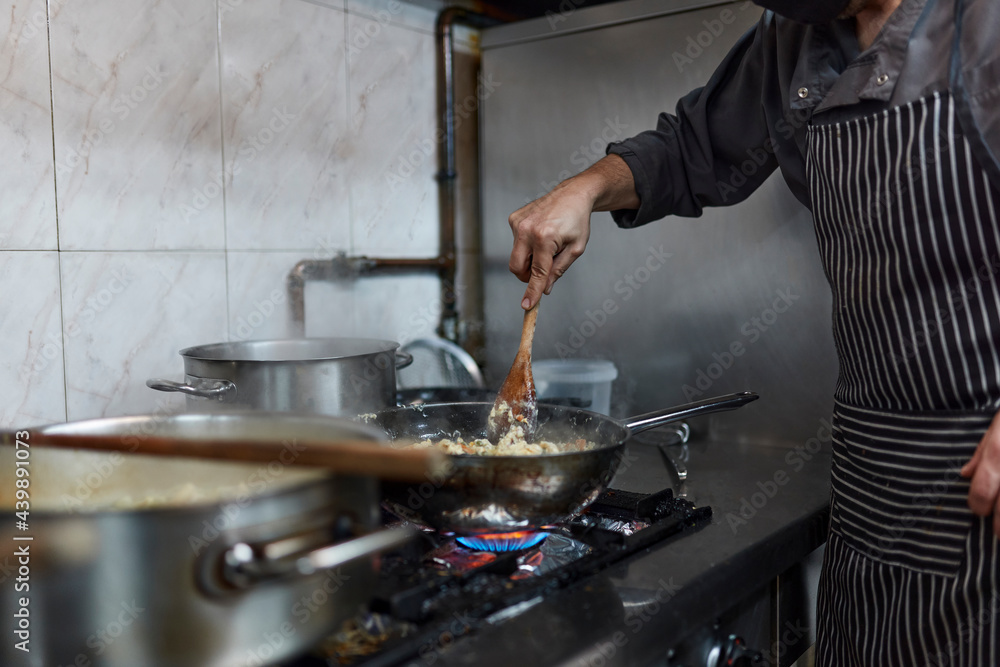 Chef cook food at industrial kitchen Chef cook food at industrial kitchen