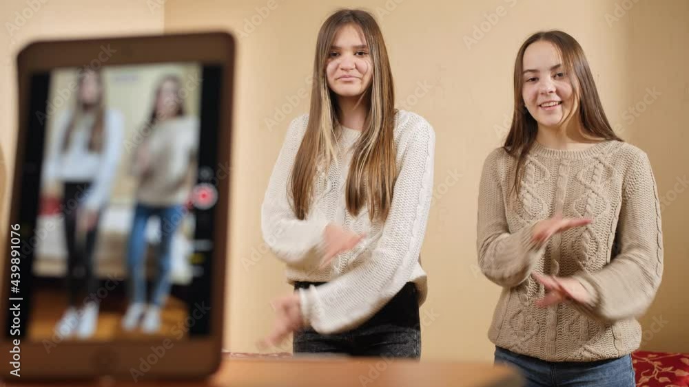 Two young teenage bloggers recording video of their dance in internet. Modern communication, social media and gadgets Two young teenage bloggers recording video of their dance in internet. Modern communication, social media and gadgets