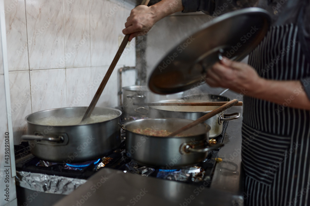 Chef cook food at industrial kitchen Chef cook food at industrial kitchen