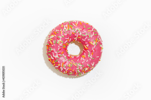 pink donut against white background