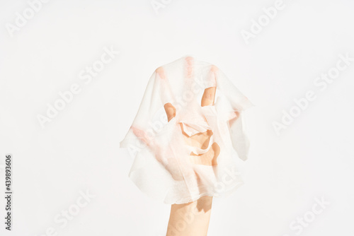 Cosmetic sheet mask on female hand photo