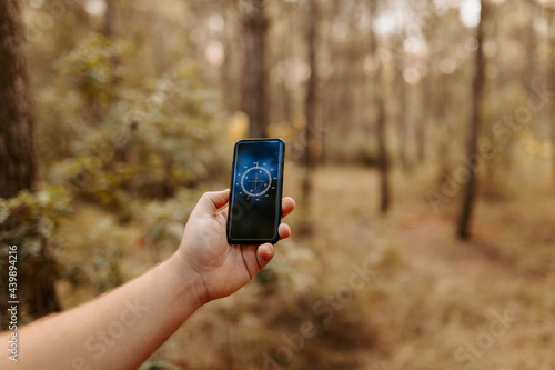 Anonymous person using smartphone app to look at compass photo