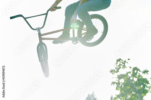 Teen jumping his BMX on a sunny day photo