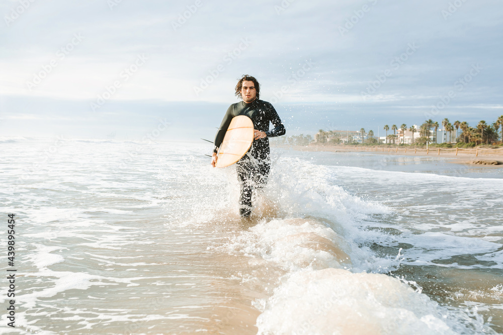 Surfer at the beach with surfboard Surfer at the beach with surfboard