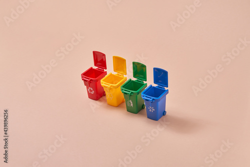 Small colored trash cans in row photo