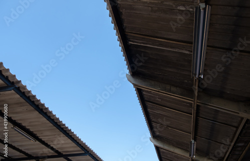 The lower view to the roof tile with the light bulb of the platform in the railway station. © trainman111