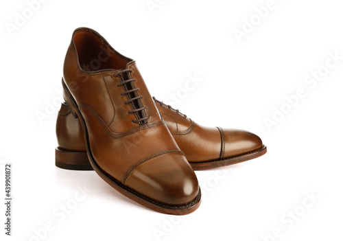 Men's brown oxford fashion shoes isolated on a white background.