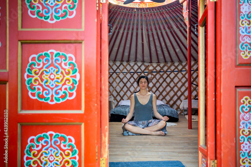 Hippie Woman Doing Meditation In A Yurt.  photo