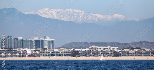 View of the land in Southern California at Marina del Rey with the snow capped mountains in the background.
