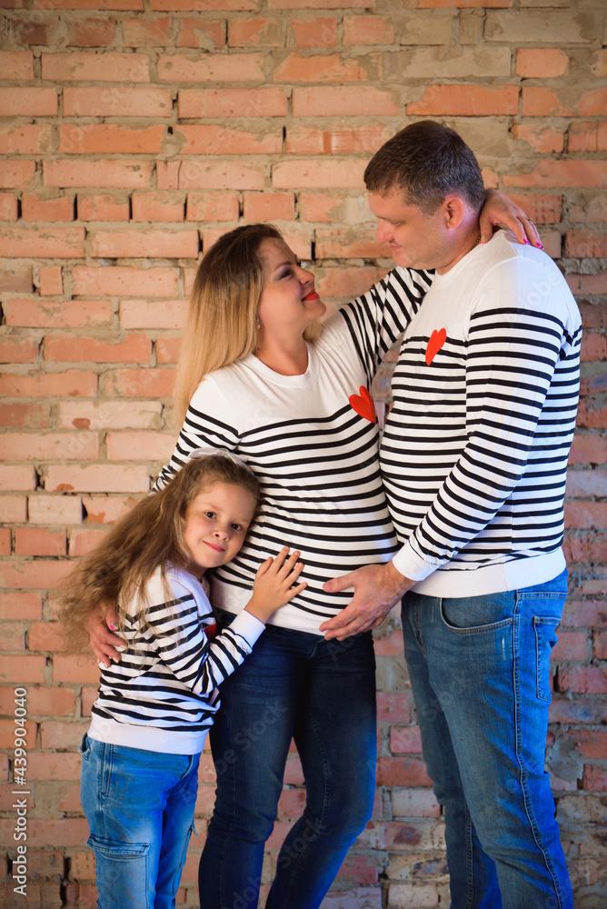 Young pregnant woman with her family, studio shoot