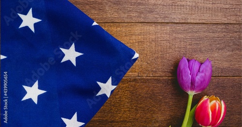 Fototapeta Naklejka Na Ścianę i Meble -  American flag and red and purple tulip flowers on wooden background