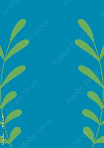 Composition of two green foliage sprigs with central copy space on blue background