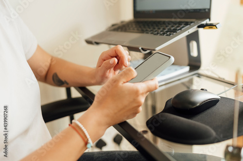 Wallpaper Mural Anonymous Woman Using a Mobile Phone for Work Torontodigital.ca