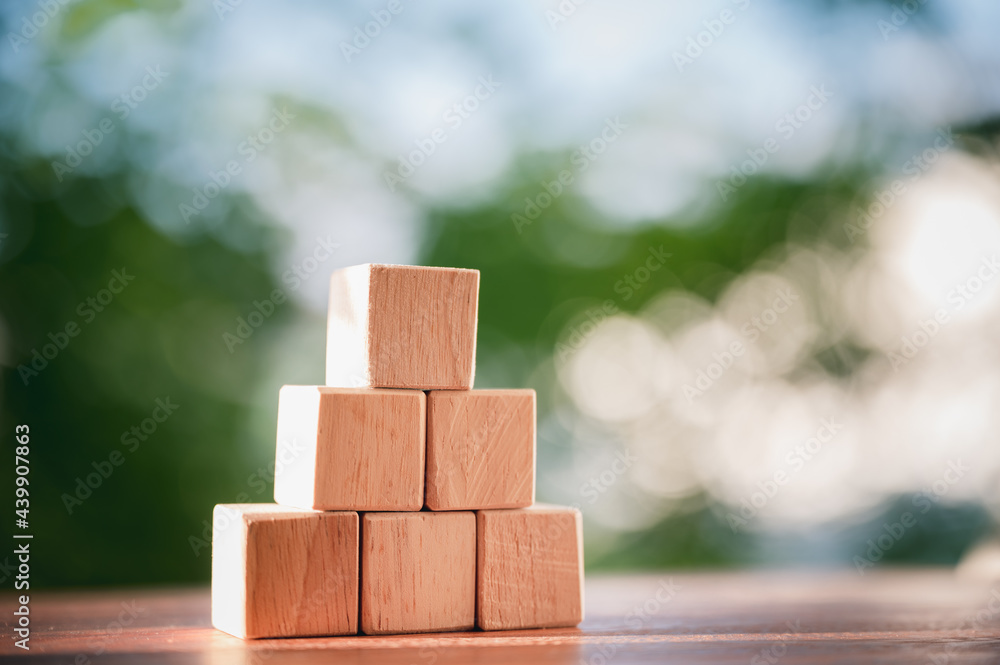 Wood block stacking as step stair to show concepts to strategy business growth to success with natural green background. Wood block stacking as step stair to show concepts to strategy business growth to success with natural green background.