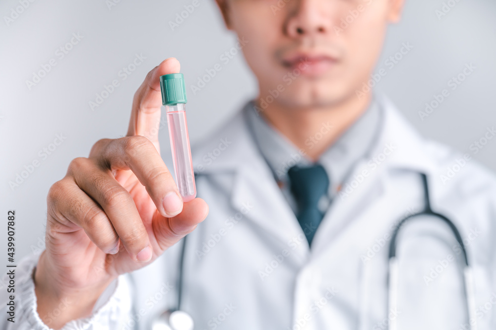 Doctor or scientist carries a syringe and a vaccine against COVID-19, vaccination and laboratory experiments. Concept of protection against the COVID-19 virus. Doctor or scientist carries a syringe and a vaccine against COVID-19, vaccination and laboratory experiments. Concept of protection against the COVID-19 virus.