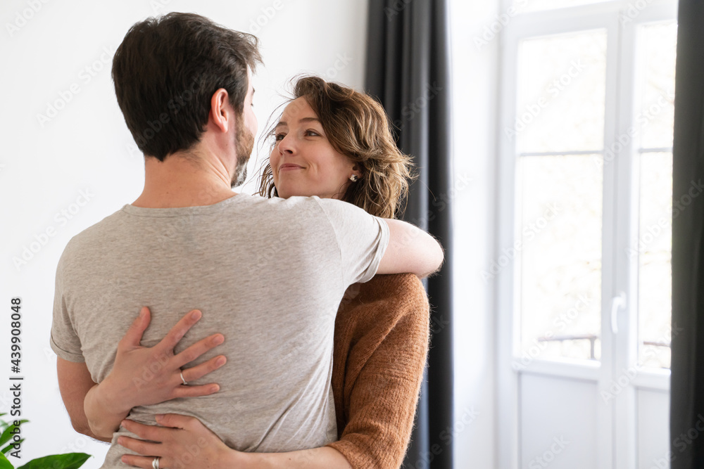 Glad Couple Hugging In New Apartment Glad Couple Hugging In New Apartment