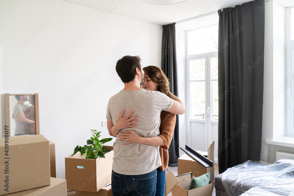 Couple Hugging In Their New Home Couple Hugging In Their New Home