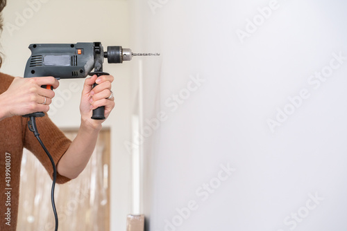 Anonymous Woman Drilling The Wall photo