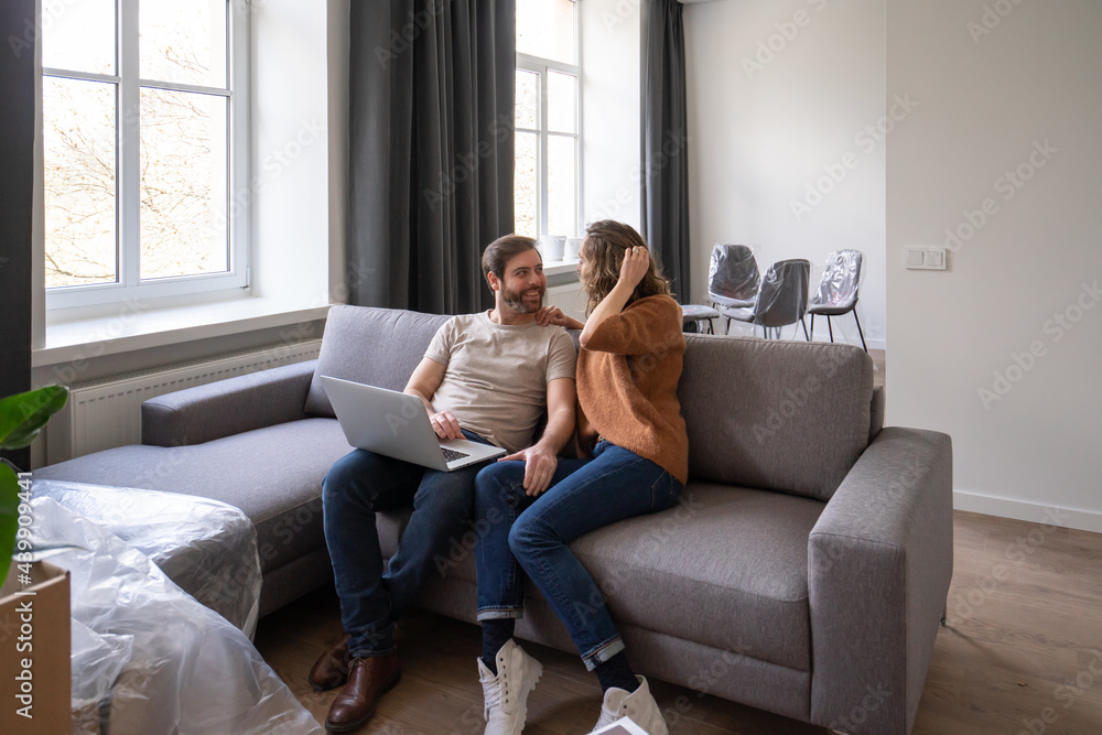 Couple Using Laptop And Talking Couple Using Laptop And Talking