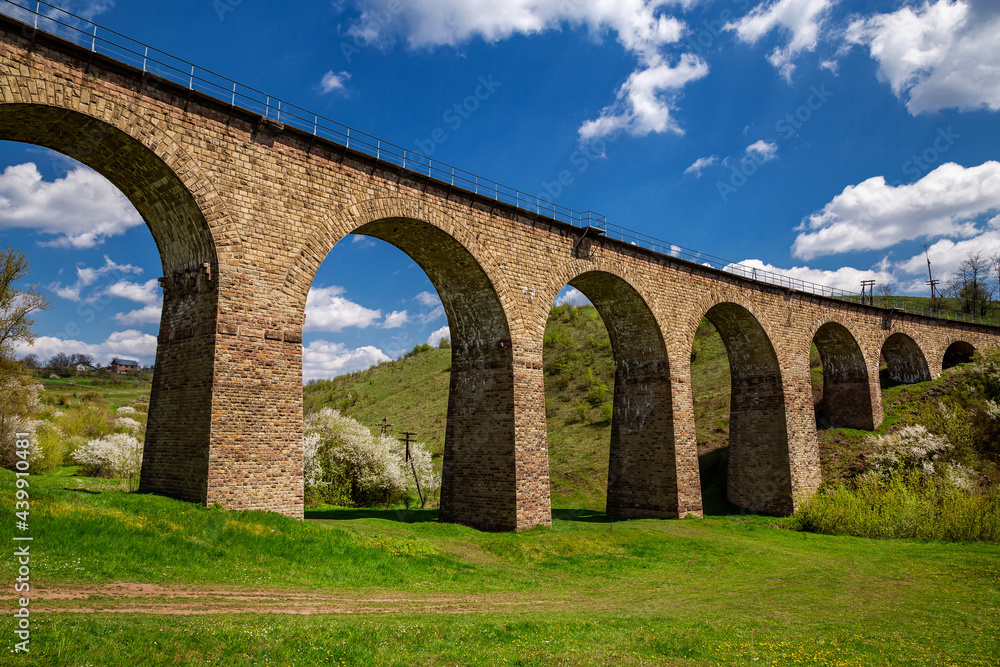 Old railway stone viaduct in the spring in sunny day.