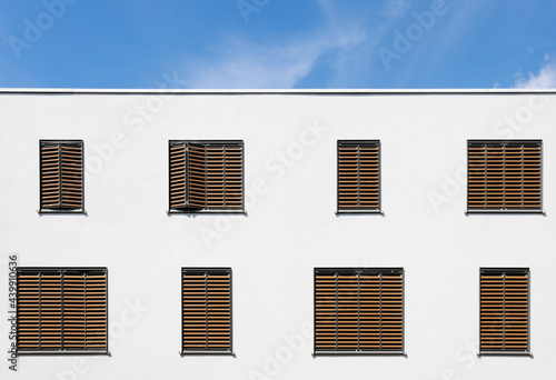 white building with brown blinds photo